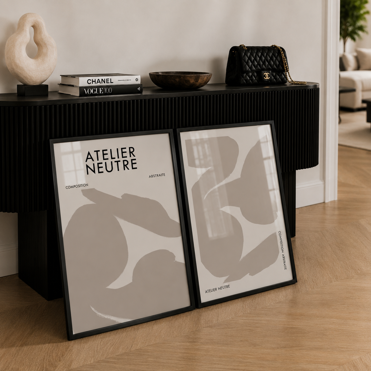 Two framed abstract art pieces on a wooden floor with a console table in the background.