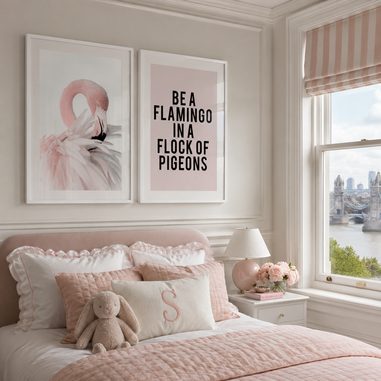 A styled bedroom interior with two framed wall art prints above a bed. One print shows a pink flamingo, and the other reads “BE A FLAMINGO IN A FLOCK OF PIGEONS” in black text on a pale pink background.