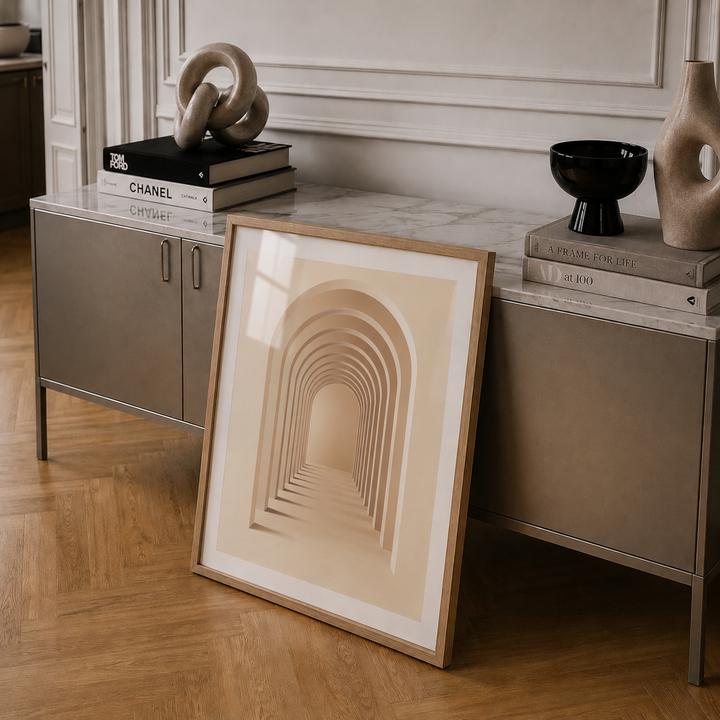 Framed abstract art leaning against a sideboard with decorative items.