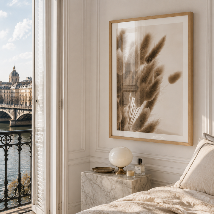 luxury wall art of bunny tails grass in an a2 oak frame in a luxury parisian bedroom with marble block side table
