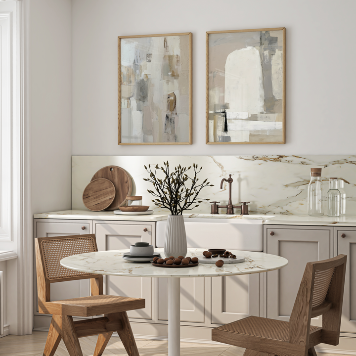 Modern kitchen with round dining table and wooden chairs, featuring abstract art on the wall.