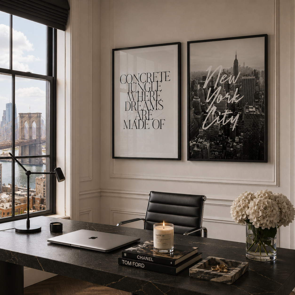 Two framed black and white New York City art prints hang on a cream paneled wall above a dark wood desk in a modern office setting.