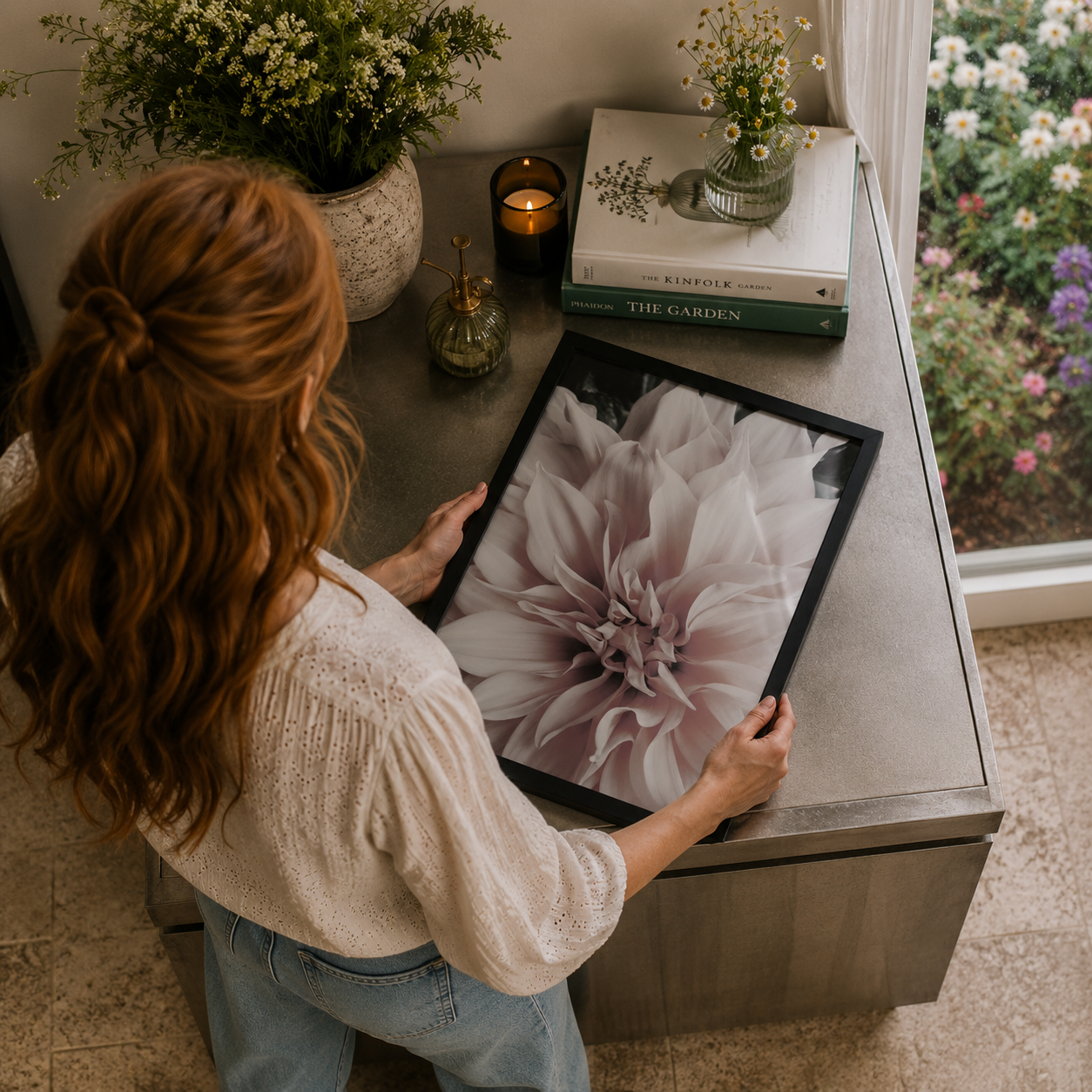 woman holding a poster of a dahlia in a luxury country kitchen