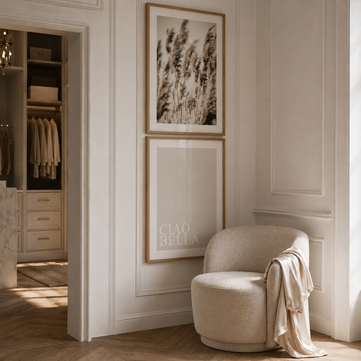 Beige armchair in a stylish room with framed artwork on the wall.