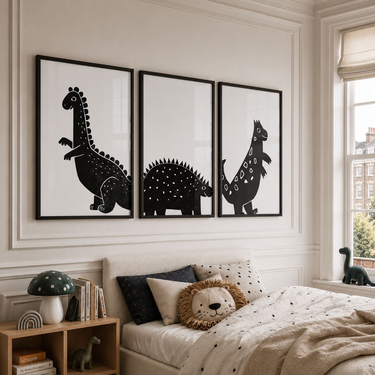 Three framed black and white dinosaur silhouette wall art prints displayed above a bed in a styled bedroom interior.