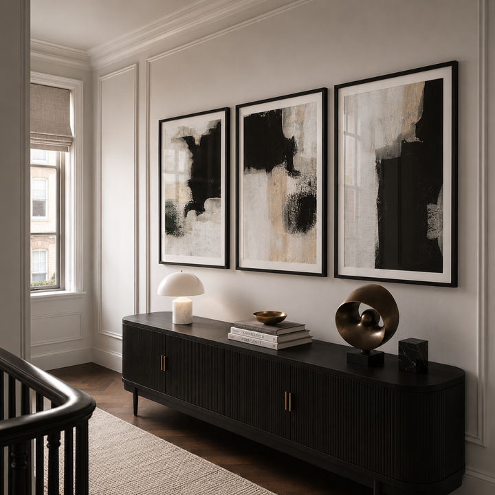 Modern interior with abstract art on the wall and a dark console table.