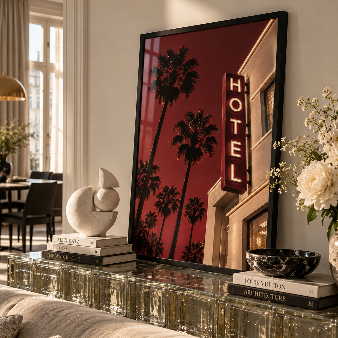 deep red hotel image in a dark wood frame on a glass block side table