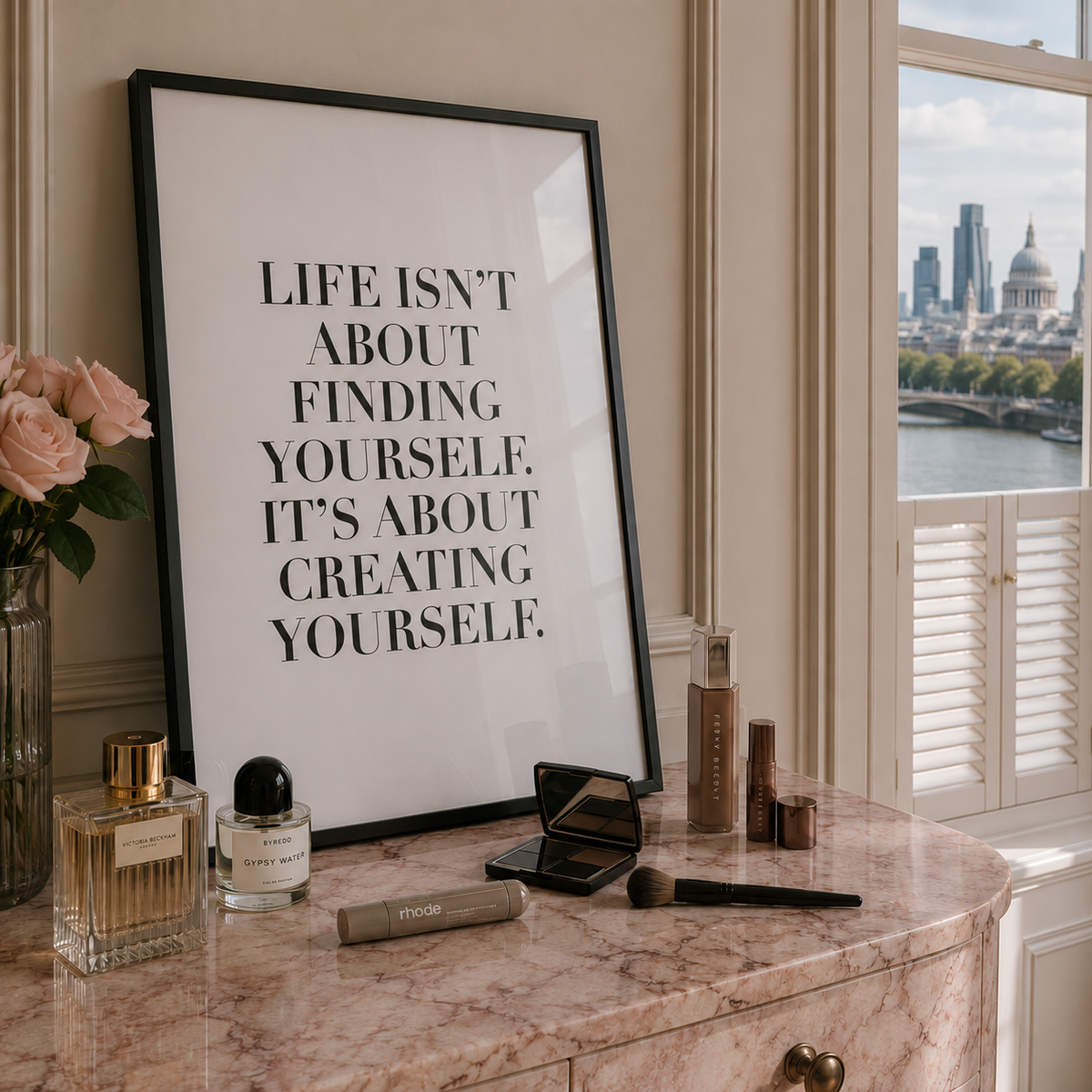 A framed motivational art print with the text 'LIFE ISN'T ABOUT FINDING YOURSELF. IT'S ABOUT CREATING YOURSELF.