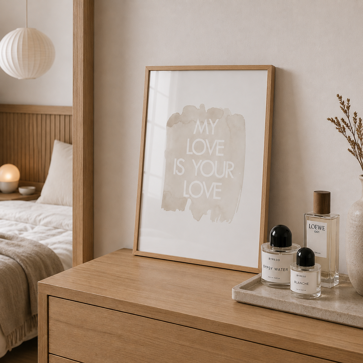 Wooden dresser with framed artwork and perfume bottles in a bedroom setting