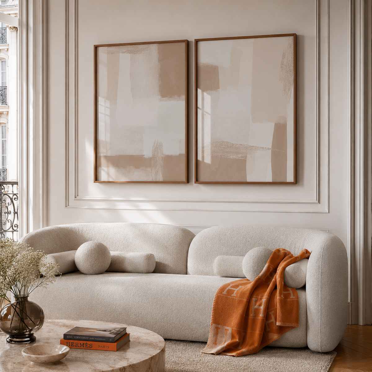 Modern living room with a beige sofa, abstract art, and decorative items.