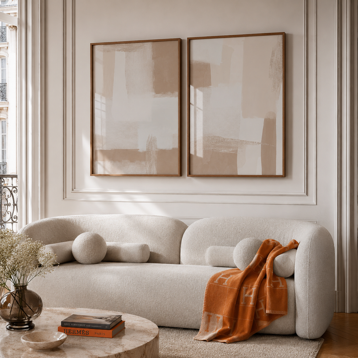 Modern living room with a beige sofa, abstract art, and decorative items.