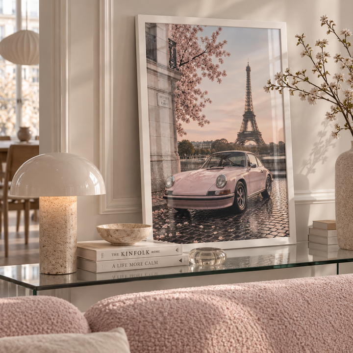 Paris in Pink Poster featuring a blush pink classic car beneath spring blossom with the Eiffel Tower in the background on a Parisian street.