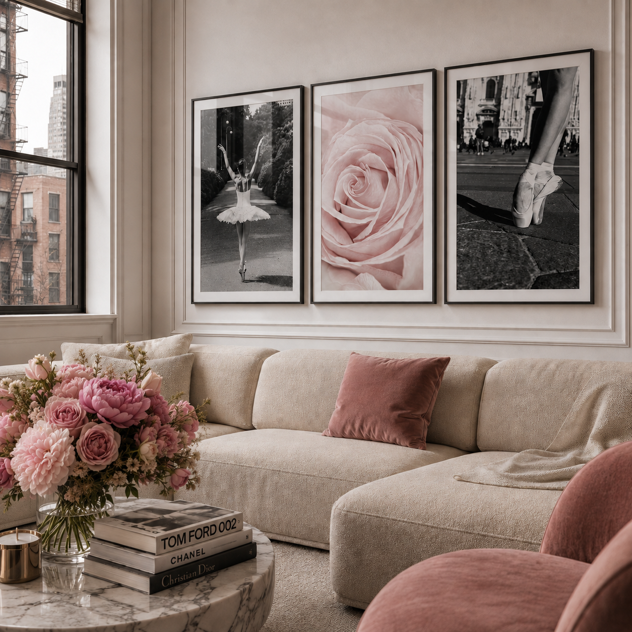 Three framed wall art prints hang above a beige sectional sofa in a styled living room. The prints feature a black-and-white ballerina, a close-up pink rose, and a black-and-white street scene with a ballerina's leg.
