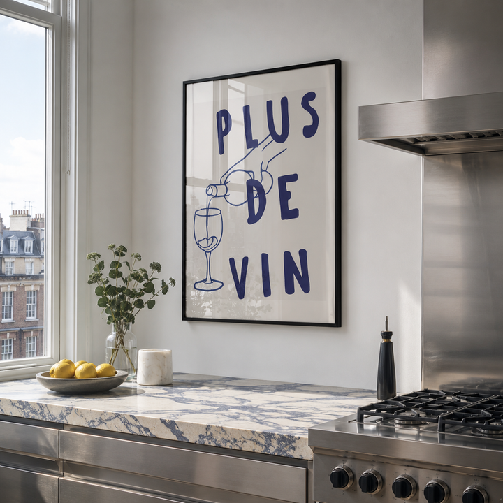 Modern kitchen with a framed poster on the wall, window, and countertop.