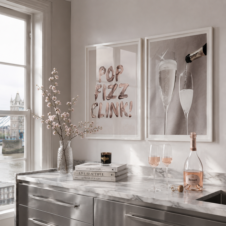 Modern kitchen counter with champagne bottle, glasses, and decorative elements.