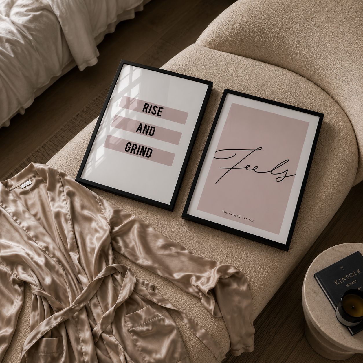 Framed prints on a bed with a robe and nightstand in the foreground