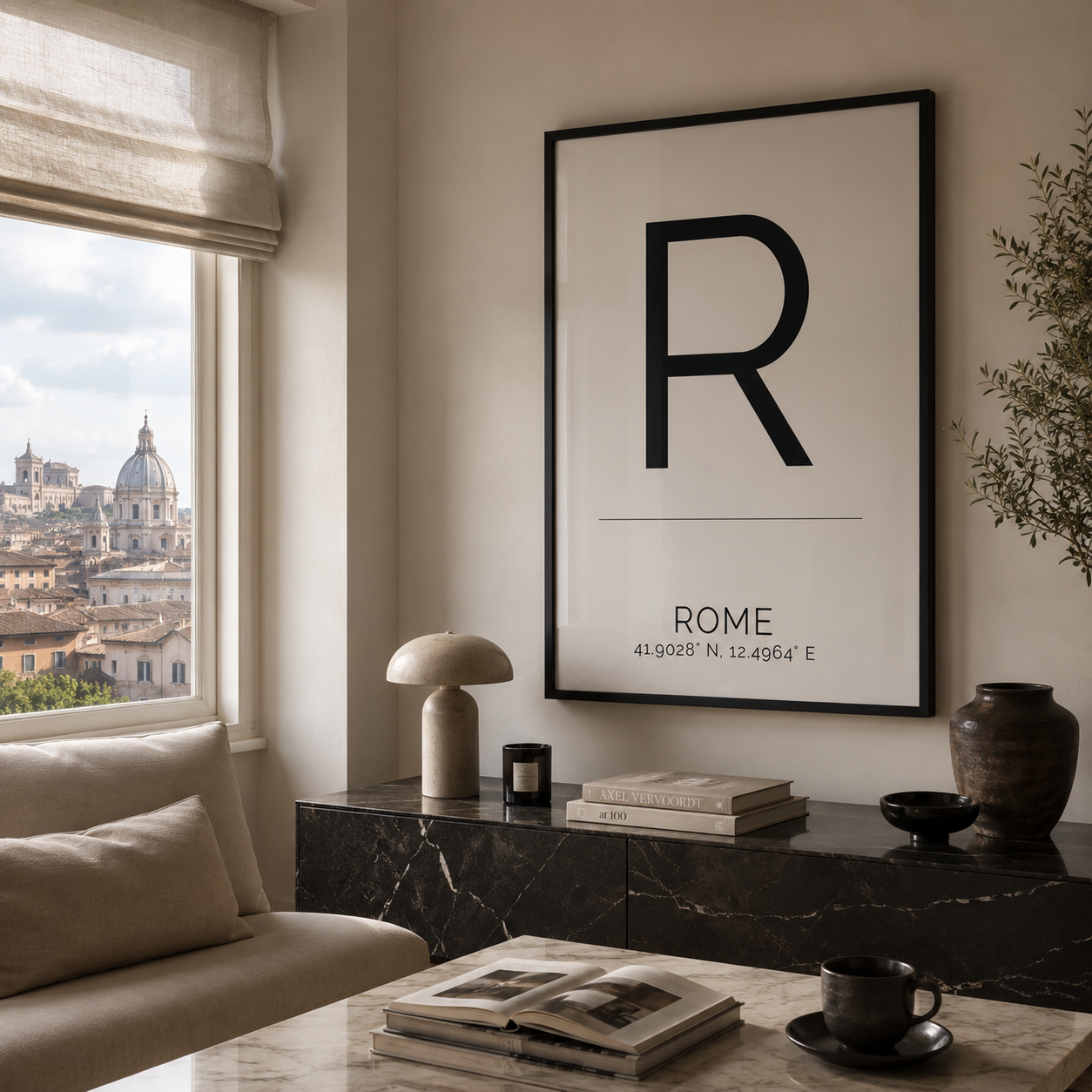 A large black-framed minimalist art print featuring a bold black letter 'R' and the text 'ROME' with coordinates, hanging on a beige wall in a modern living room setting.
