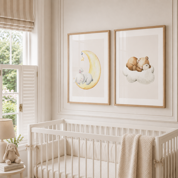 Two framed watercolor nursery art prints hanging on a cream wall above a white wooden crib. The left print shows a baby bunny sleeping on a yellow crescent moon, and the right print shows a teddy bear sleeping on a cloud.