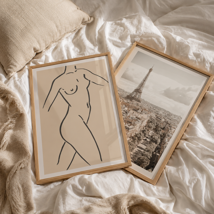 Two framed artworks on a luxury bed