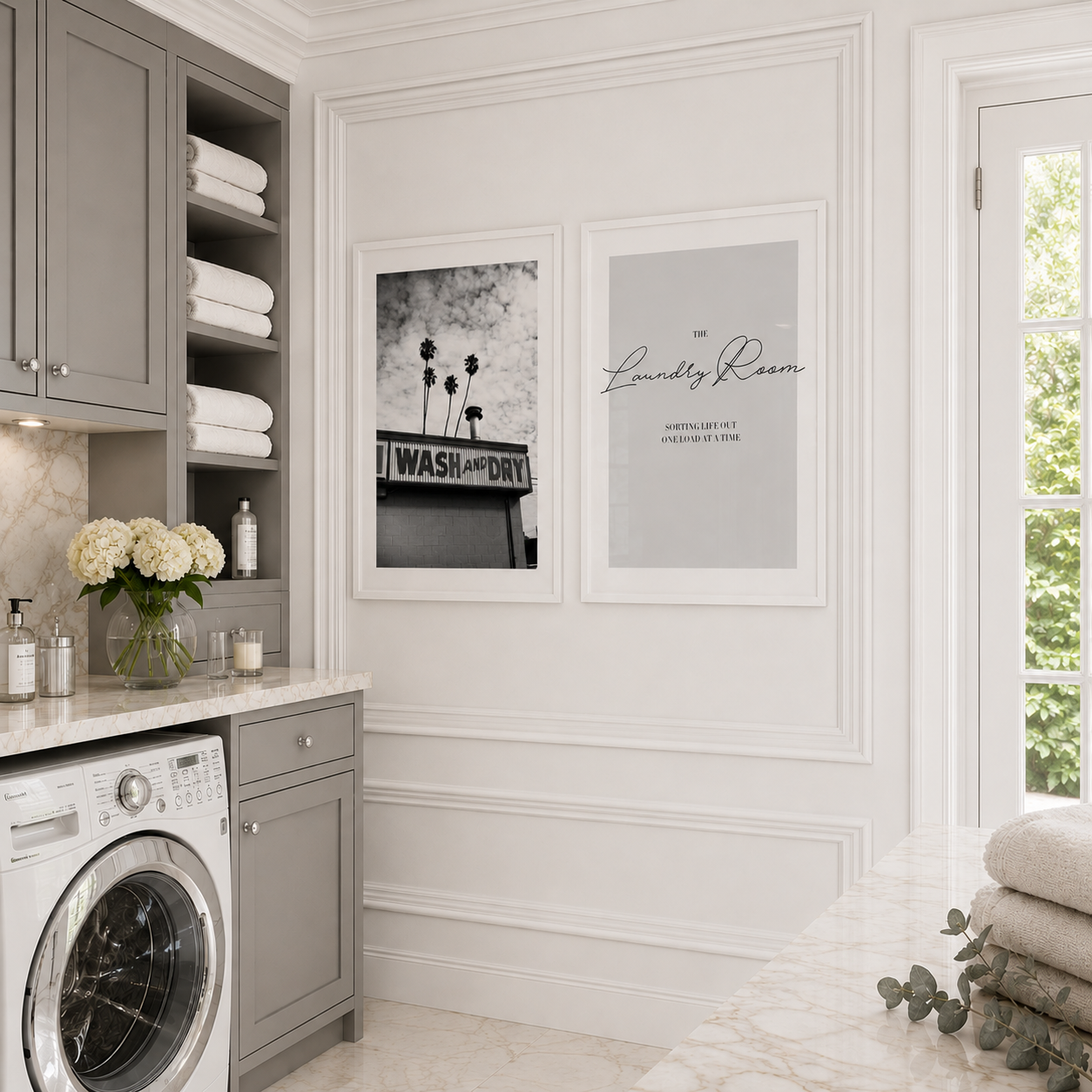 Modern laundry room with washing machine, shelves, and framed pictures on the wall.