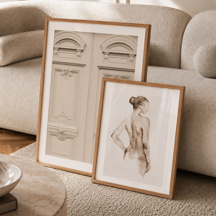 Two framed artworks on a textured surface with a neutral background