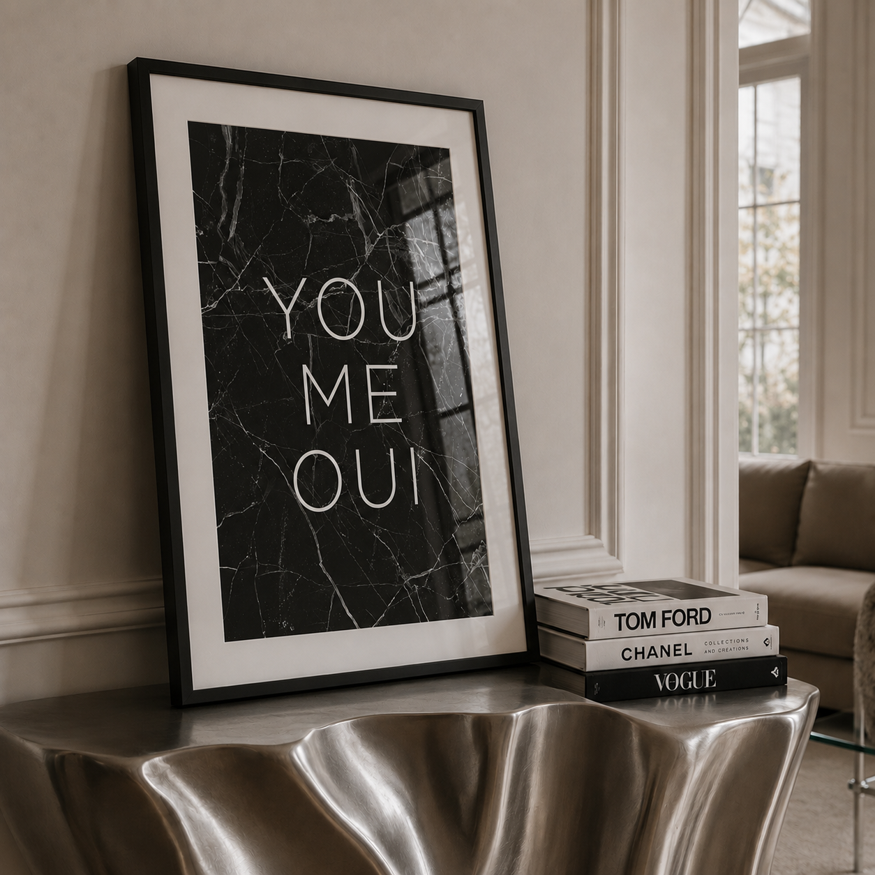 Framed poster with 'YOU ME OUI' text on a metallic surface in a room.